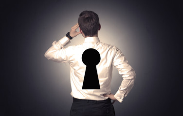 Man standing with black keyhole on his back