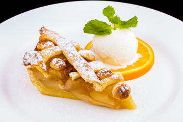 Apple pie with vanilla ice cream on white plate