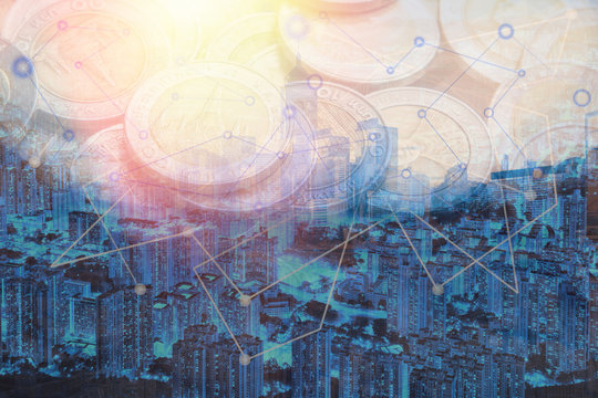Double exposure money coins on trading graph and stock market board background with capital financial city. Business investment concept.