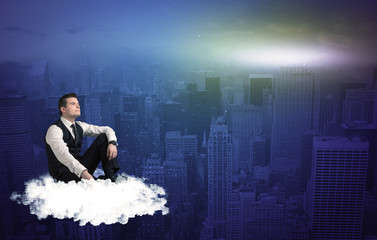 Man sitting on a cloud above the city