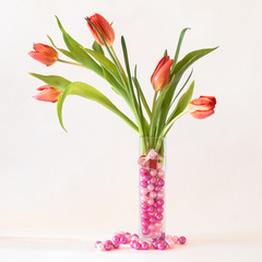 Valentine's Day bouquet of tulips in a vase with pink pearls