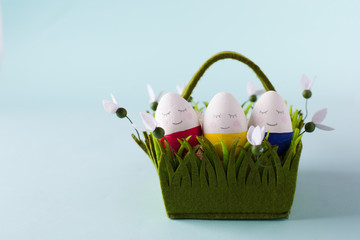 funny, colorful, lovely and kind Easter eggs - painted with hands, lie in a basket. Background for Easter greetings, concept
