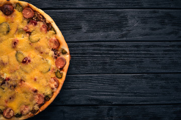 Obraz na płótnie Canvas Homemade pizza on a wooden background. Top view. Copy space.