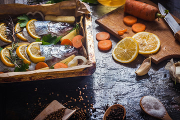 Salmon on rustic table with fresh ingredients for cooking