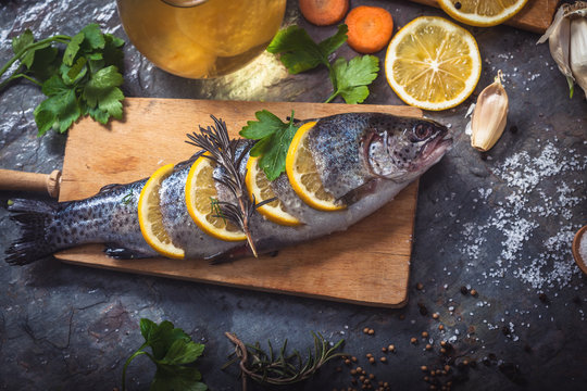 Salmon on rustic table with fresh ingredients for cooking