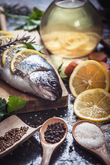 Salmon on rustic table with fresh ingredients for cooking