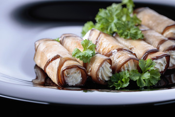 Eggplant rolls stuffed with cheese and garlic.