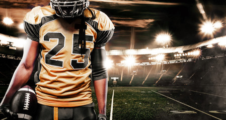 Plakat American football sportsman player on stadium. Sport wallpaper with copyspace.