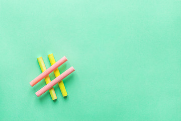 Hashtag Sign Made from Crossed Colorful Pink Yellow Chalks Crayons on Turquoise Background. Social...