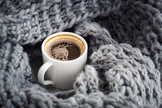 a cup of aromatic coffee wrapped in wool snod