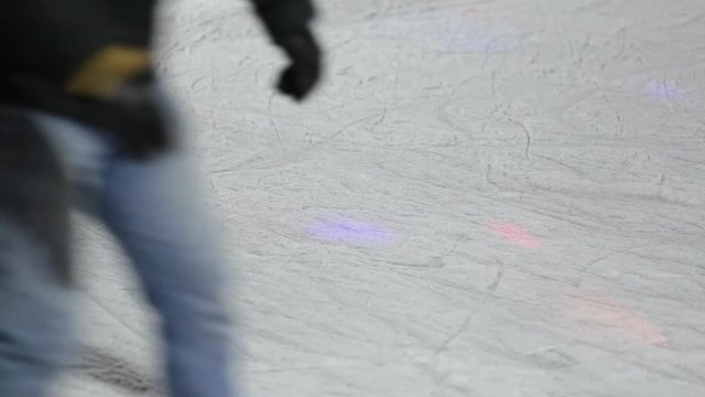 Many people skating on ice in winter outdoors at public rink. 