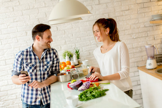 Young couple preparing healthy meal in the kitchen