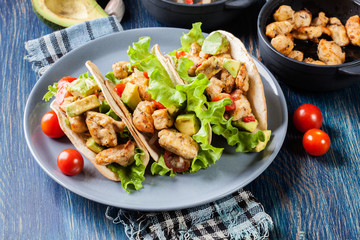 Authentic mexican tacos with chicken and salsa with avocado, tomatoes and chillies