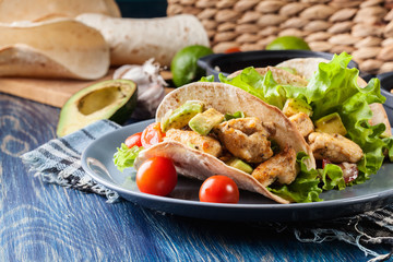 Authentic mexican tacos with chicken and salsa with avocado, tomatoes and chillies