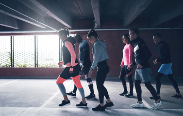 Group of multiracial friends urban running