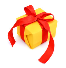 gift yellow box with red ribbon bow close up isolated on white background