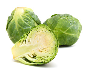 freshly brussel sprouts and some whole ones on a white background