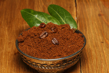 Coffee beans, ground, cinnamon, anise on a wooden background. View from above.