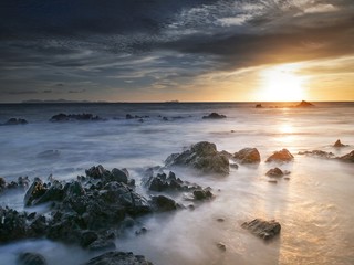 Rocks in the ocean at sunset time