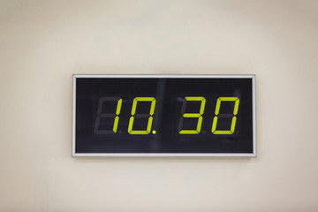 Black digital clock on a white background showing time 10 hours 30 minutes