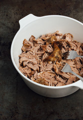Traditional American Slow cooked Pulled pork made of boneless shoulder roast shredded with two forks cooked in crockpot or on bbq grill for Mexican Pork Carnitas, taco, tortillas or barbecue party