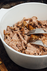 Traditional American Slow cooked Pulled pork made of boneless shoulder roast shredded with two forks cooked in crockpot or on bbq grill for Mexican Pork Carnitas, taco, tortillas or barbecue party