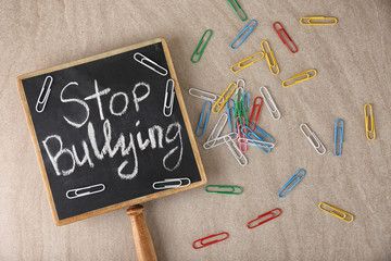 Chalkboard with text "Stop bullying" on light background