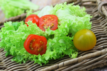 Cherry tomatoes on green lettuce, closeup
