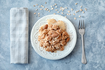 Plate with apple crisp on table, top view