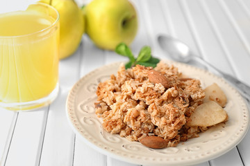 Plate with apple crisp on table, closeup