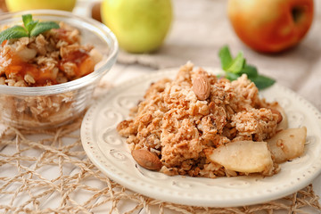 Plate with apple crisp on table, closeup