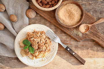 Plate with apple crisp on table, top view