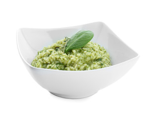Dish with tasty spinach risotto on white background