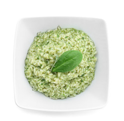 Dish with tasty spinach risotto on white background