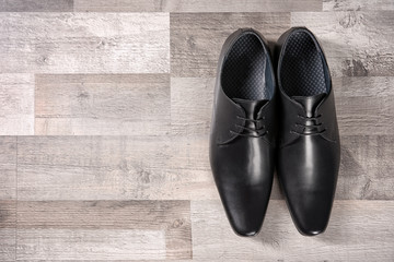 Elegant leather men's shoes on floor, top view