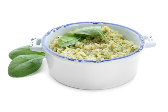 Dish with tasty spinach risotto on white background