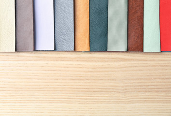 Colorful fabric samples on wooden background