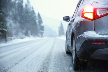 Fototapeta premium Car on country road in winter day