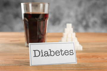 Card with word "Diabetes" and blurred sugar on background