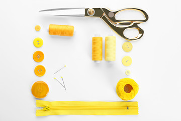 Composition with sewing threads and accessories on white background, top view