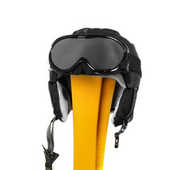 Yellow skis with goggles and helmet on white background. Winter vacation concept