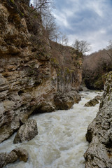 Fototapeta na wymiar rough mountain river with white, hadzhohskaya tasnina gorge, Republic of Adygea