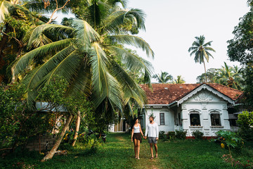 The couple in the home garden. A guy and a girl rent a house. A couple in love travels. Man and woman in Asia. Loving couple. Newly married couple