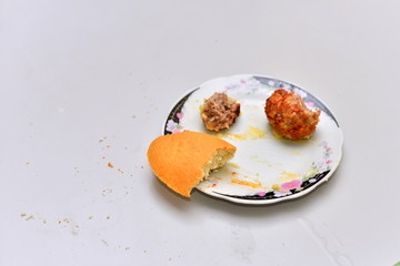 Food waste. Top view piece of food remains on plate.