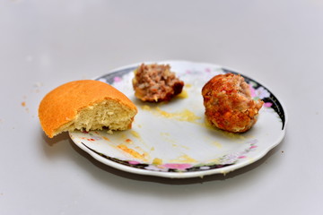 Food waste. Top view piece of food remains on plate.