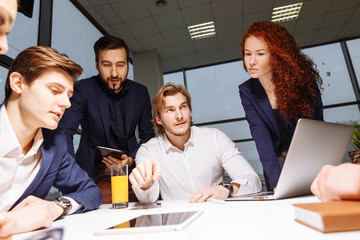 Business executive delivering presentation to his colleagues during meeting or in-house business...
