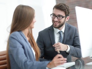 colleagues discussing information on a computer