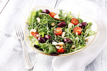 Salad with cheese and fresh vegetables and arugula. Greek salad.