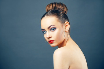 Beautiful young woman portrait with big earrings