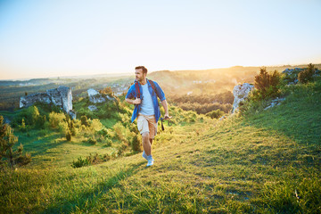 Man admiring view of mountains during hiking trip